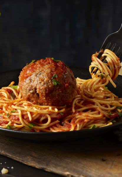 Fork Picking up Spaghetti on Plate with Meatball and Sauce